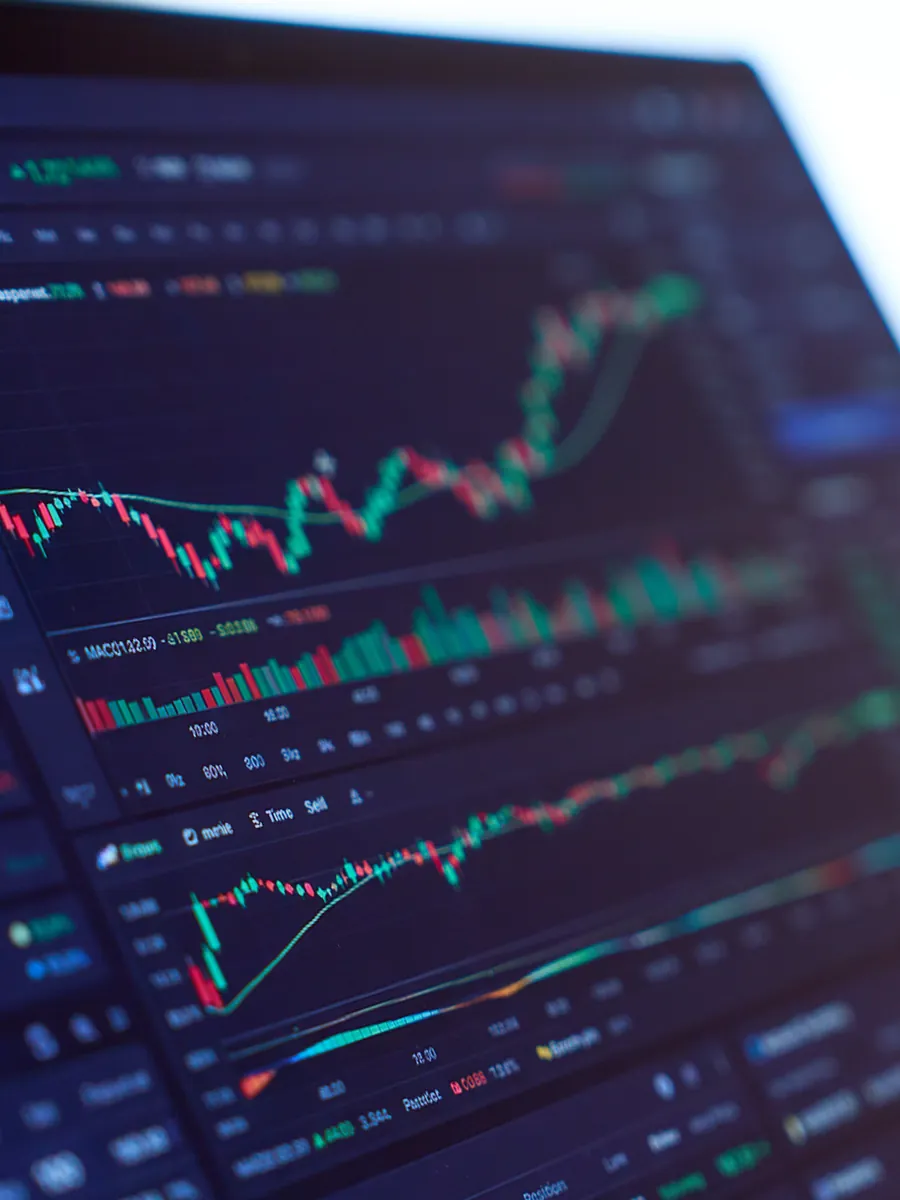 A trader studying charts on screen