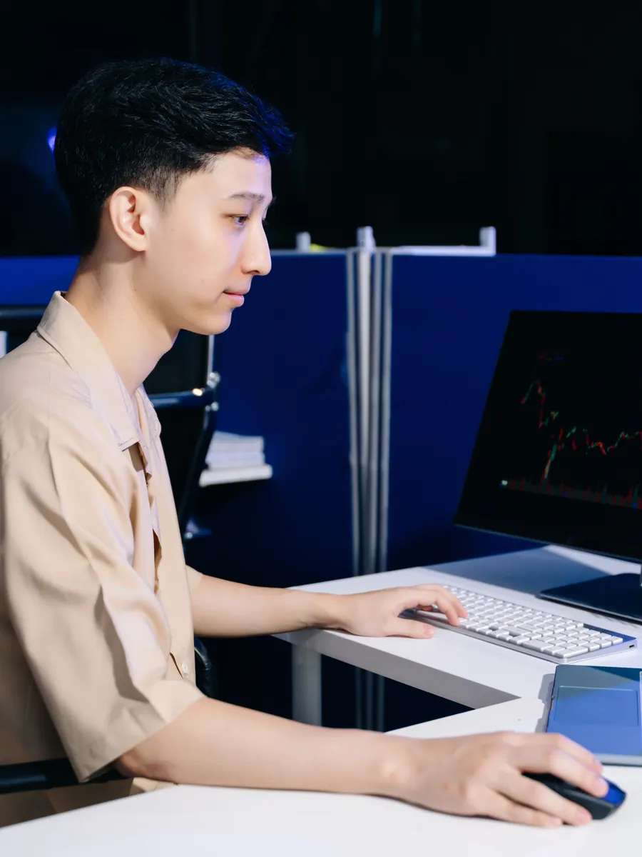 A trader reviewing the market on a laptop